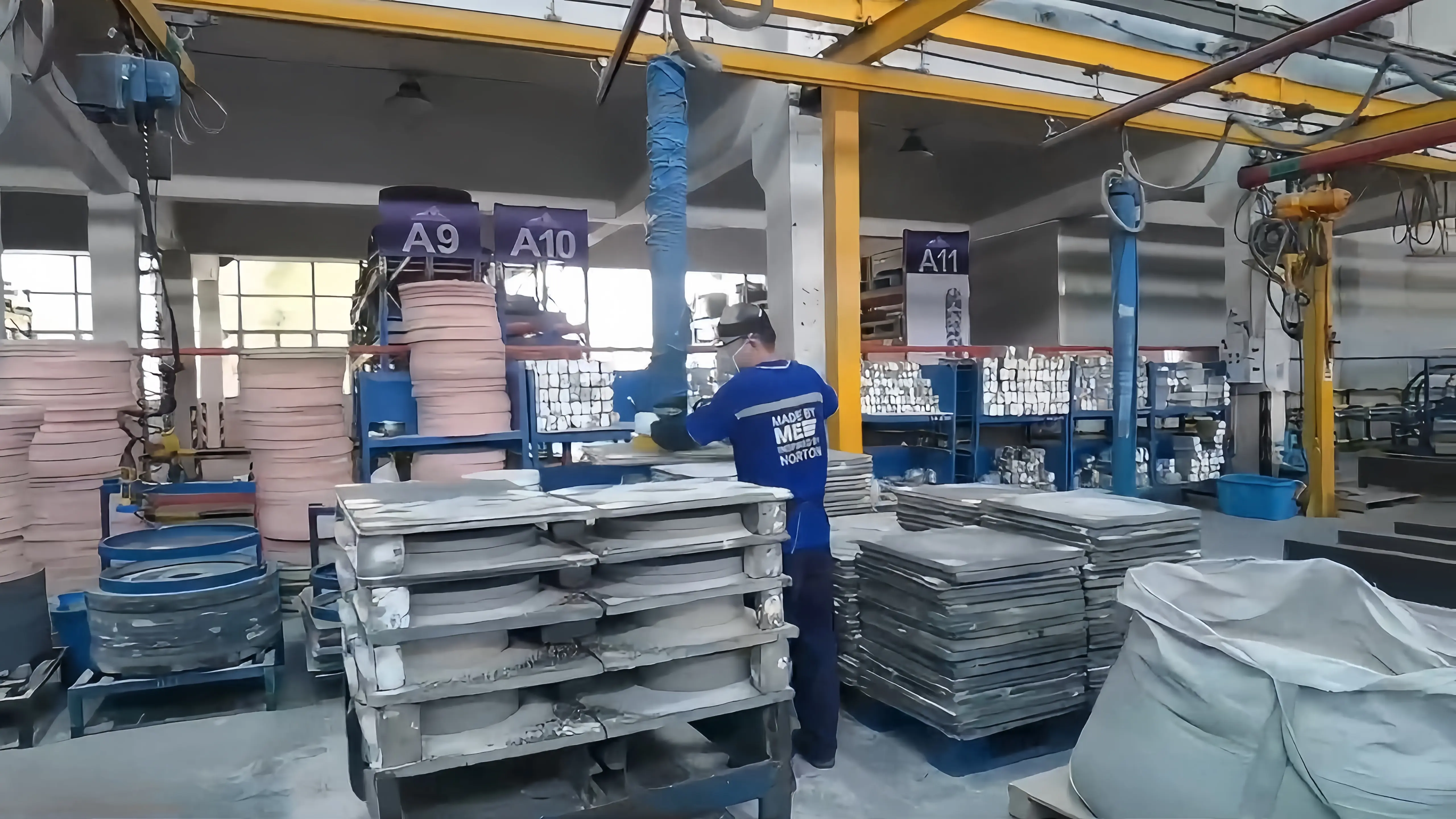 BILLIONS LIFTER vacuum tube lifter handling uneven stone slabs in a workshop